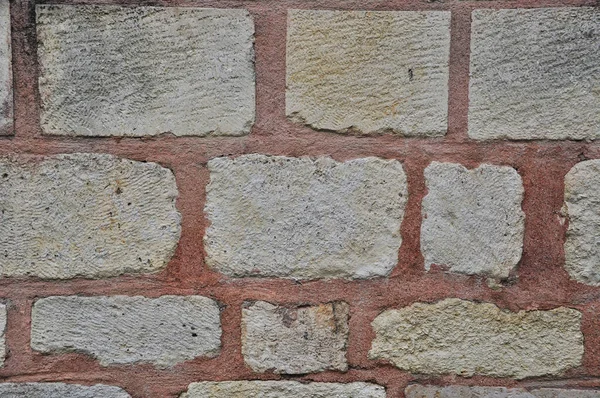 A wall of large stones. Background, texture. Stone masonry with jointing.