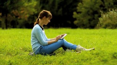 Tablet bilgisayar kullanan genç bir kadın