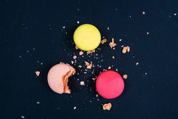 Colourful stack of macaroons isolated on plain black background. Copyspace