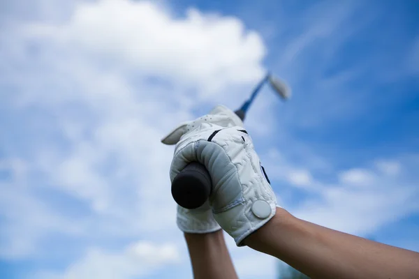 Golfer hands in gloves holding iron in the sky — Stock Photo, Image