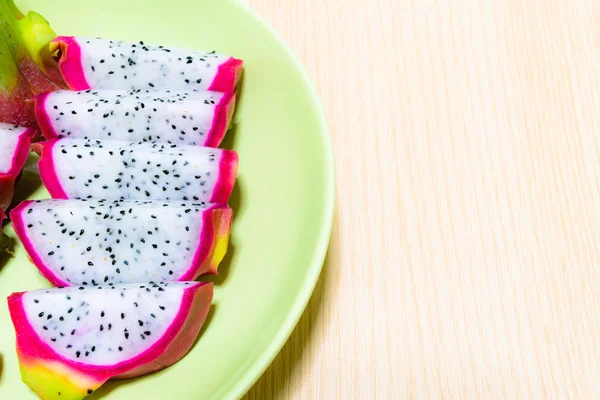 Dragon fruit (Pitaya) on dish with wood background — Stock Photo, Image