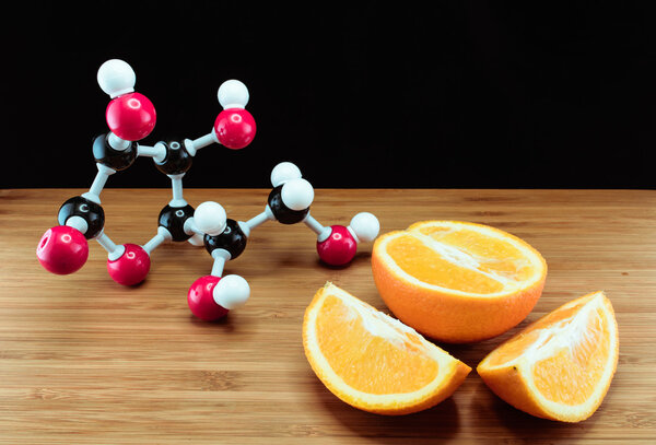 Orange and vitamin C structure model (Ascorbic acid)