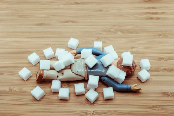 Drop Dead doll man under falling sugar cubes for the concept of — Stock Photo, Image