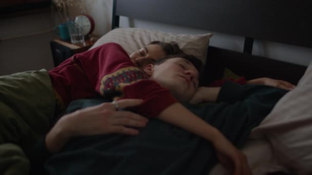 A couple sleep in a cozy house and are hugging each other — Stock Video