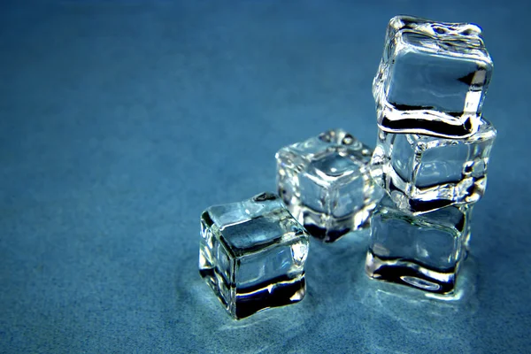 Ice cubes over blue. — Stock Photo, Image