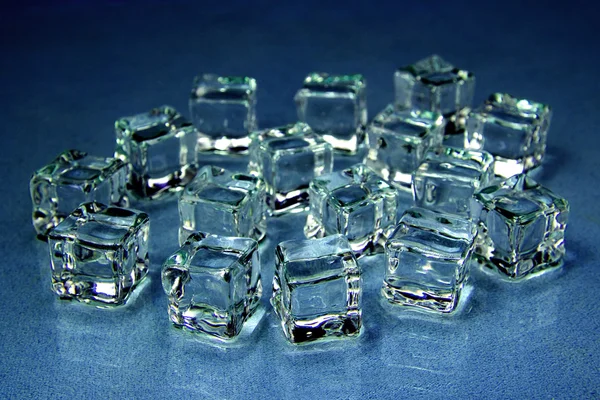 Ice cubes over blue. — Stock Photo, Image
