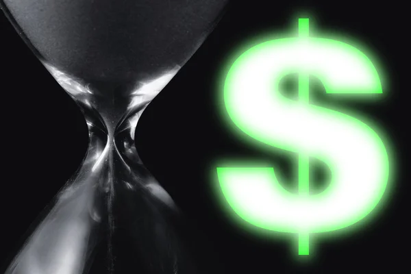 Close up of hourglass with green hologram's symbol of dollar. — Stock Photo, Image