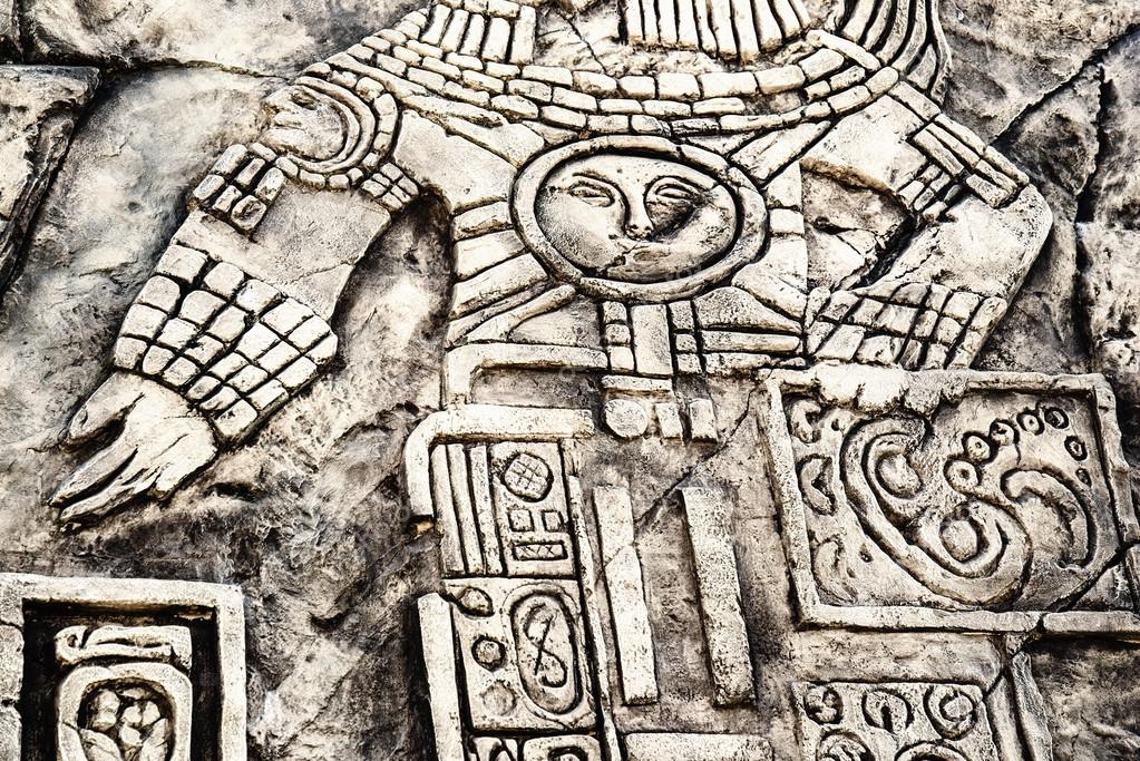 Ancient Mayan hieroglyphics in stone