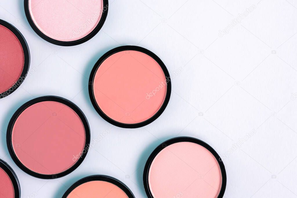 Pink blush and compact face powder on pastel blue background. Banner. Makeup. Cosmetic products. Tonal foundation. 