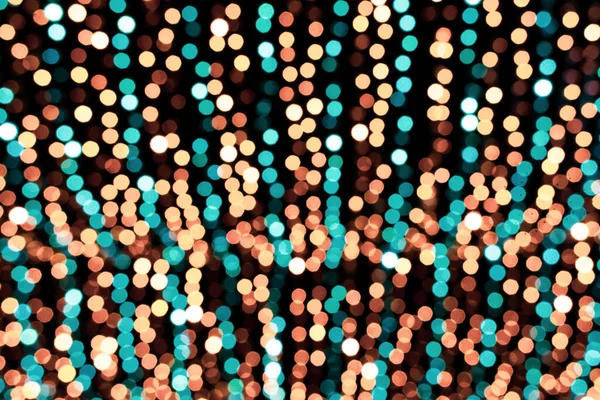 Christmas lights. Festive New Year blurred blue, golden yellow, turquoise and black background. Beautiful sparkling backdrop, texture. Bokeh. Copy space. Place for text. Template. Trendy shades. Xmas.