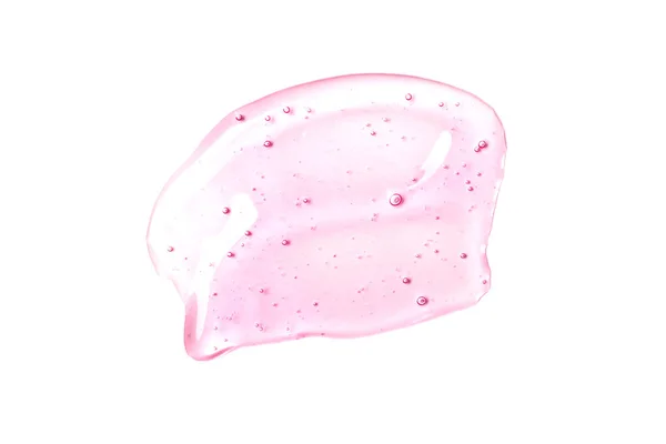 Bela mancha de gel transparente rosa de ácido hialurônico no fundo branco isolado. O soro da cara está borrado.. — Fotografia de Stock