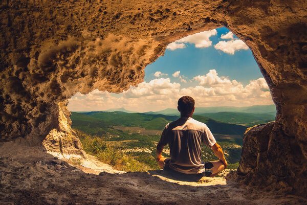 Man  meditates  in a cave
