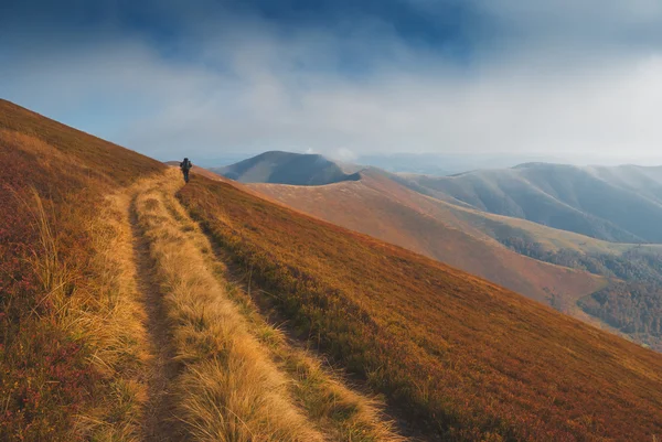 Hiker go by track on Borzhava ridge — Stock Photo, Image