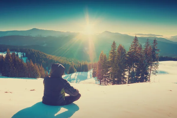 Senderista relajarse en una nieve fresca y disfrutar de la puesta de sol. Colores vintage —  Fotos de Stock