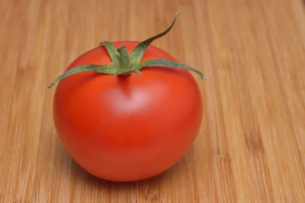 Pomidory na rustykalnym drewnianym tle — Zdjęcie stockowe