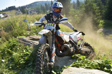 SIBIU, ROMANIA - JULY 16: A competitor in Red Bull ROMANIACS Hard Enduro Rally with a KTM motorcycle. The hardest enduro rally in the world. July 12-16, 2016 in Sibiu, Romania.