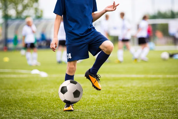 Boy Playing Soccer Football Match on a Sports Stadium