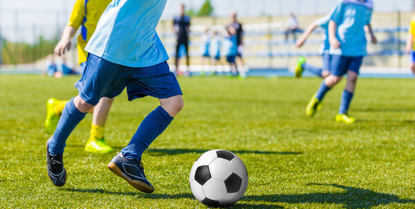 Boys playing football soccer match game