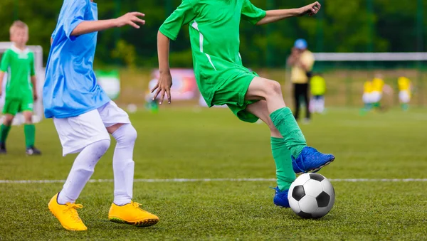 Football soccer game of youth teams. Running young players kicking soccer ball on sports field — Stock Photo, Image