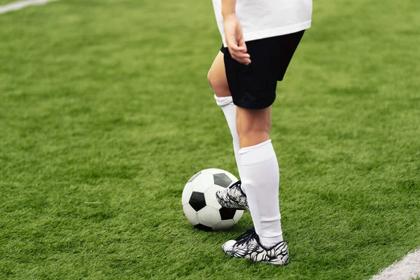 白と黒のサッカーボールとサッカー選手 芝生の上で若いアスリートキックボール ホワイトサッカージャージー制服キックボールの男の子 — ストック写真