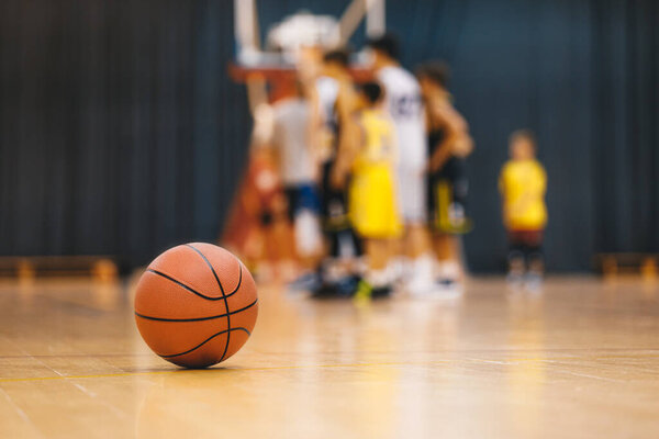 Basketball on Wooden Court. Youth Basketball Practice and Kids Team Training in Sports Hall
