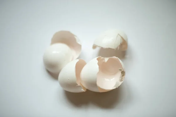 Leftover eggshell close-up on a white background.