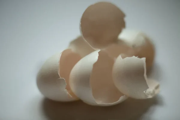 Leftover eggshell close-up on a white background.