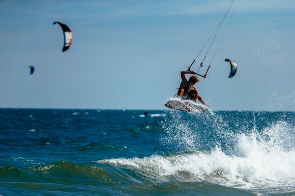 kite surfer rides waves