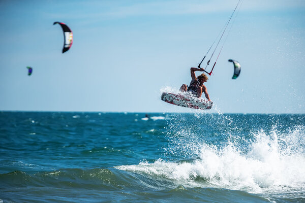 kite surfer rides waves