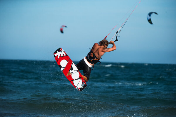 kite surfer rides waves