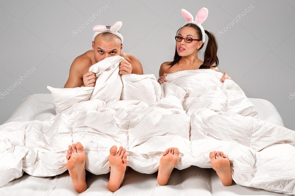 Couple in  rabbit costumes in bed