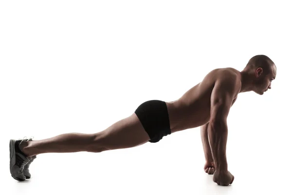 Man performing push-ups exercise on fists — Stock Photo, Image