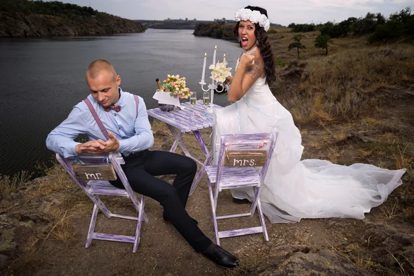 Bride and groom next to table