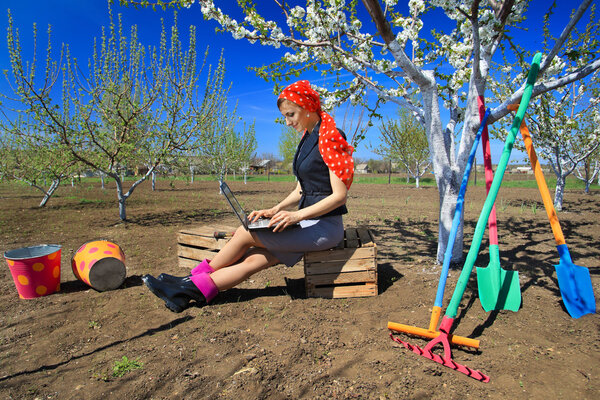 woman using laptop in garden