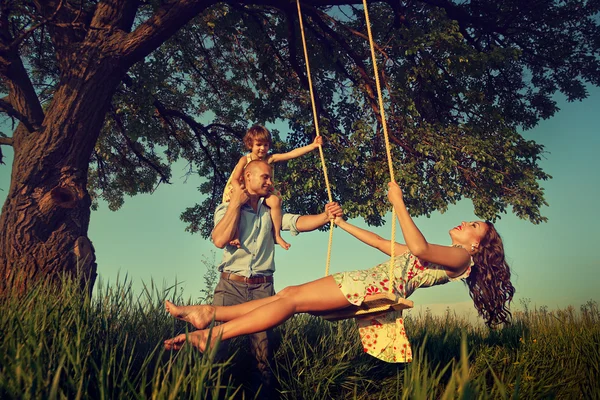 Mom with family  on  swing — Stock Photo, Image