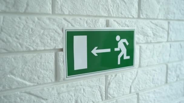 Exit emergency sign in 4K slow motion. An exit sign hangs on a wall. 4k stock footage. — Stock Video