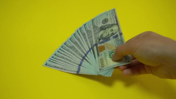 El dinero cae sobre la mesa. Manos de hombre Considere billetes de dólar en una mesa de madera. Imágenes de vídeo 4K. — Vídeos de Stock