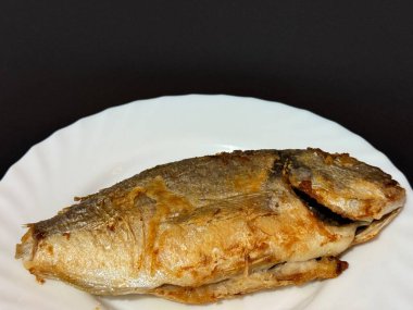 A close-up shot of fried fish. Cooking delicious food at home.