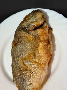 A close-up shot of fried fish. Cooking delicious food at home.