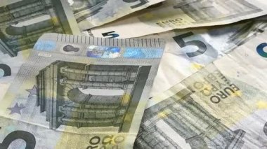 Macro shots of swirling euros highlight financial themes such as pensions, taxes, income, and losses. Money, economics, and financial literacy.