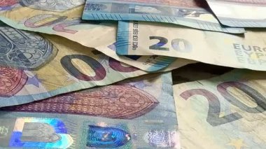 Macro shots of swirling euros highlight financial themes such as pensions, taxes, income, and losses. Money, economics, and financial literacy.