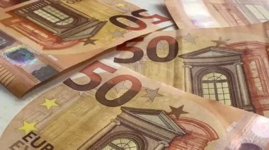 Macro shots of swirling euros highlight financial themes such as pensions, taxes, income, and losses. Money, economics, and financial literacy.