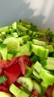 Macro shot of a salad with fresh vegetables and herbs. Freshly made Mediterranean salad on plate. 
