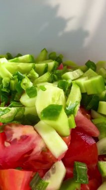 Macro shot of a salad with fresh vegetables and herbs. Freshly made Mediterranean salad on plate. 