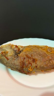 A close-up shot of fried fish. Cooking delicious food at home.