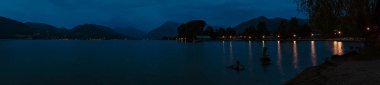 High resolution stitched panorama of a long exposure night shot with reflections at the famous Tegernsee, Bad Wiessee, Bavaria, Germany