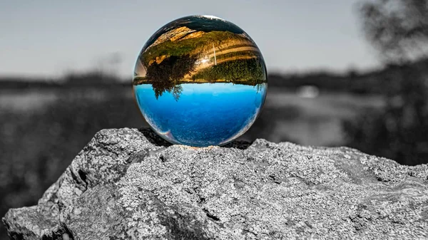 Crystal ball landscape shot with black and white background outside the sphere at Bad Griesbach, Bavaria, Germany