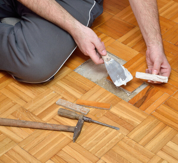 Man Attaching Damaged Parquet