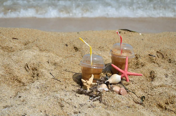 Фраппы холодного кофе на пляже — стоковое фото