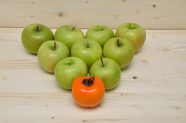 Green apples and orange kaki apple — Stock Photo, Image
